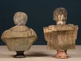 two busts of a man and a woman sitting on top of each other