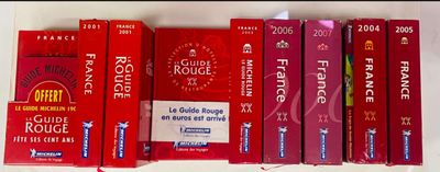 several red boxes of cigarettes are lined up on a shelf