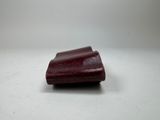 a small red object on a table with a white background