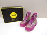 purple boots with glitter on them sitting next to a black box