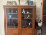 a wooden cabinet with glass doors in a living room