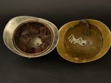 pair of antique brass bowls with lids on a black background