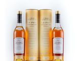 a couple of bottles of whisky sitting next to each other