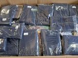a cardboard box filled with many different types of shirts