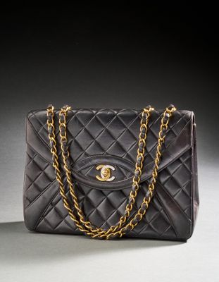 a black chanel bag with a gold chain strap