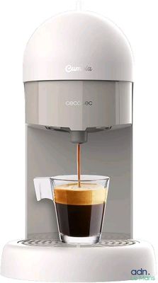 an image of a white coffee machine with a cup of coffee