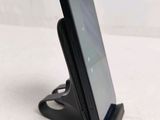 a cell phone that is on a stand on a table