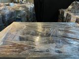 a table covered with plastic wrap in a warehouse