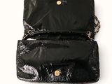 a black purse with a gold chain hanging from it