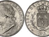 a silver coin with a crown on top of it