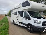 an image of a motorhome parked on the side of the road