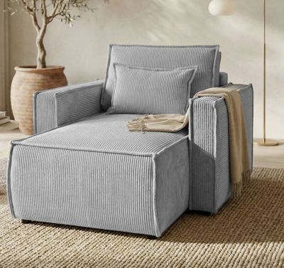 an image of a chair and ottoman in a living room
