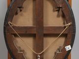 an old wooden easel with a large wooden wheel on top of it