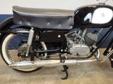 a black and white motorcycle parked in a garage