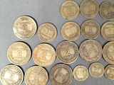 a bunch of old coins sitting on top of a table