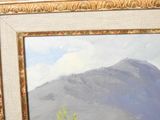 a picture of a painting of a mountain in a gold frame