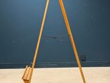 an old wooden easer stands in front of a blue wall
