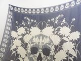 a black and white picture of a skull and flowers on a blanket