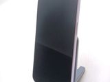 a cell phone that is on a stand on a table
