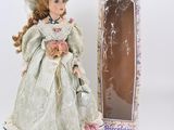 a doll that is in a box next to a doll