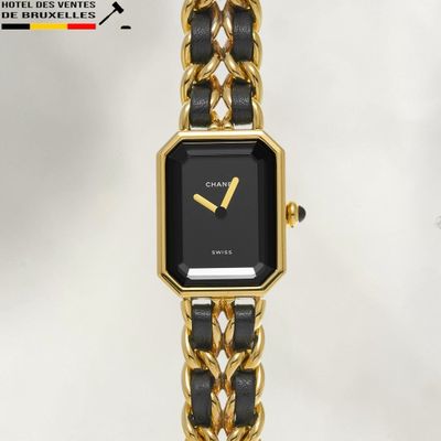 an image of a black and gold watch with a chain bracelet