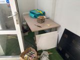 a table with a bag of food on it next to a window