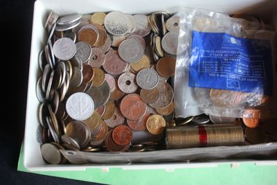 a box full of coins and other items in it