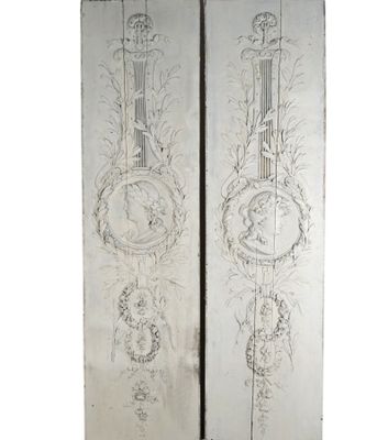 pair of antique silver painted wall panels with musical instruments on them