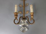 a wall mounted candle holder with two candles on it