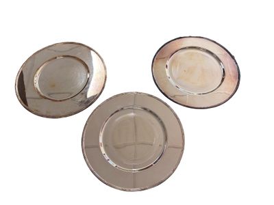 three plates that are sitting on a white surface
