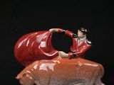 a figurine of a man riding on a pig