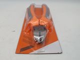 an orange and black toy car in a package