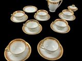 many cups and saucers that are arranged in the shape of a heart