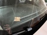 a man sitting in the back seat of a car using a cell phone