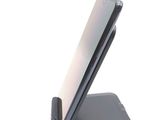 a phone that is sitting on a stand on a white surface