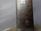 a close up of a metal object with writing on it