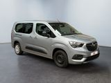 the silver van is parked in a white room with a black floor