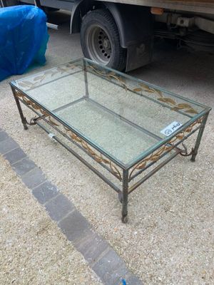 une table basse en verre dotée d'un piètement métallique