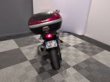 a motorcycle that is parked in a room with a checkered floor