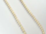 a white pearl necklace with a gold clasp on a white background