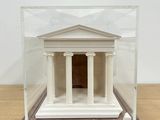 a small model of a building inside of a glass case