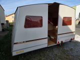 an image of a camper trailer parked on the side of the road