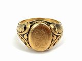 a close up of a gold ring with a coin on it