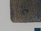 a small piece of cloth with blue spots on it