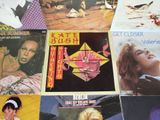 many different album covers on the table together
