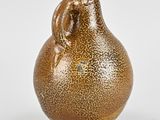 an image of a brown vase sitting on top of a white surface