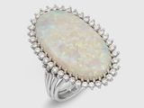 une bague en oplite blanche sertie d'un diamant, sur fond blanc
