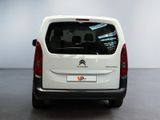 the back of a white citrole van parked in a showroom