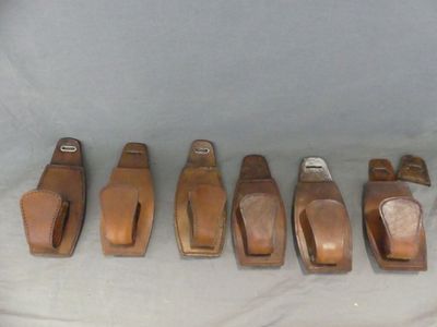 six pieces of leather are lined up in a row on a table