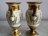 two vases that are sitting on a marble table
